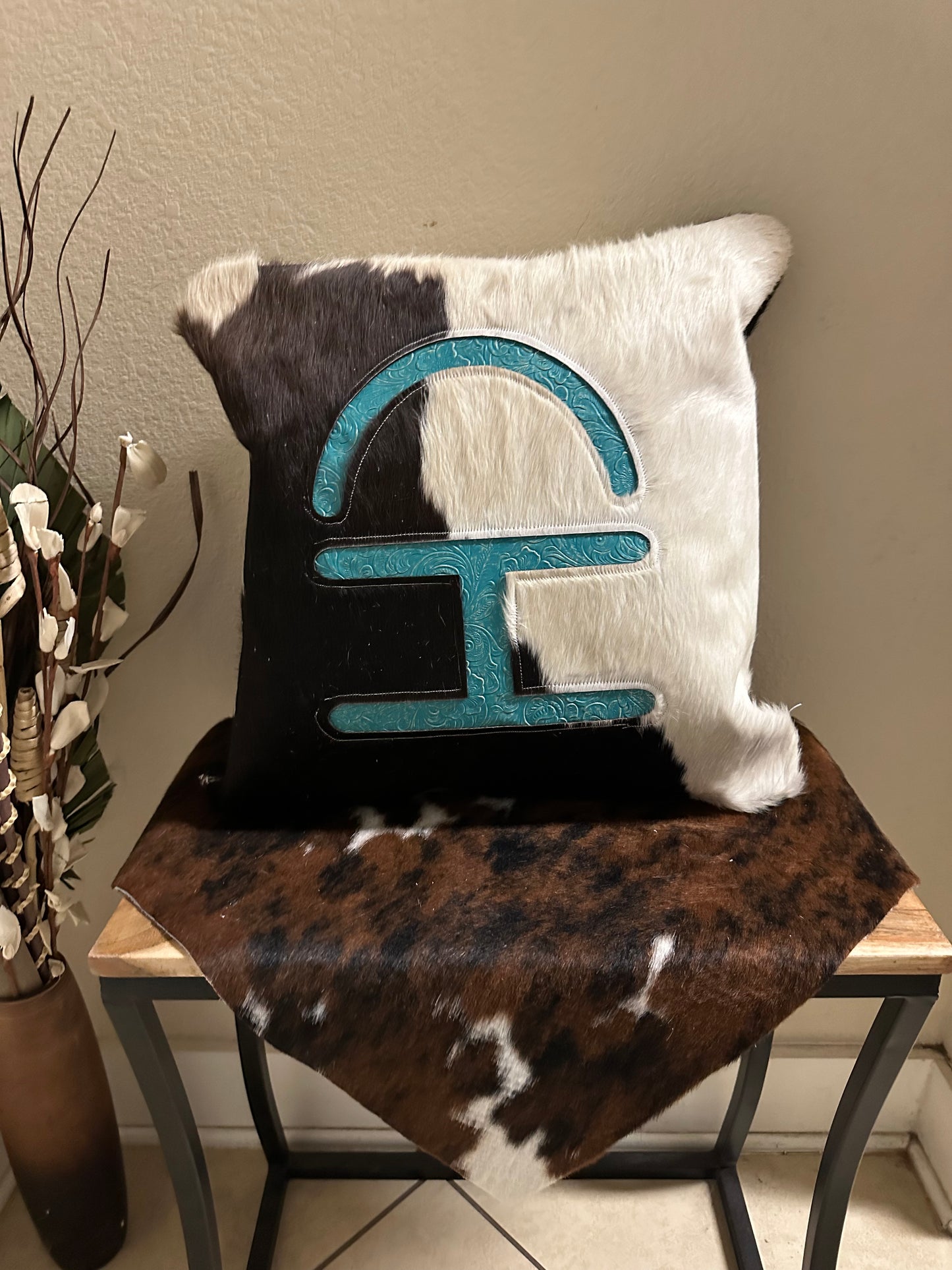 Cowhide pillow with brand cutout