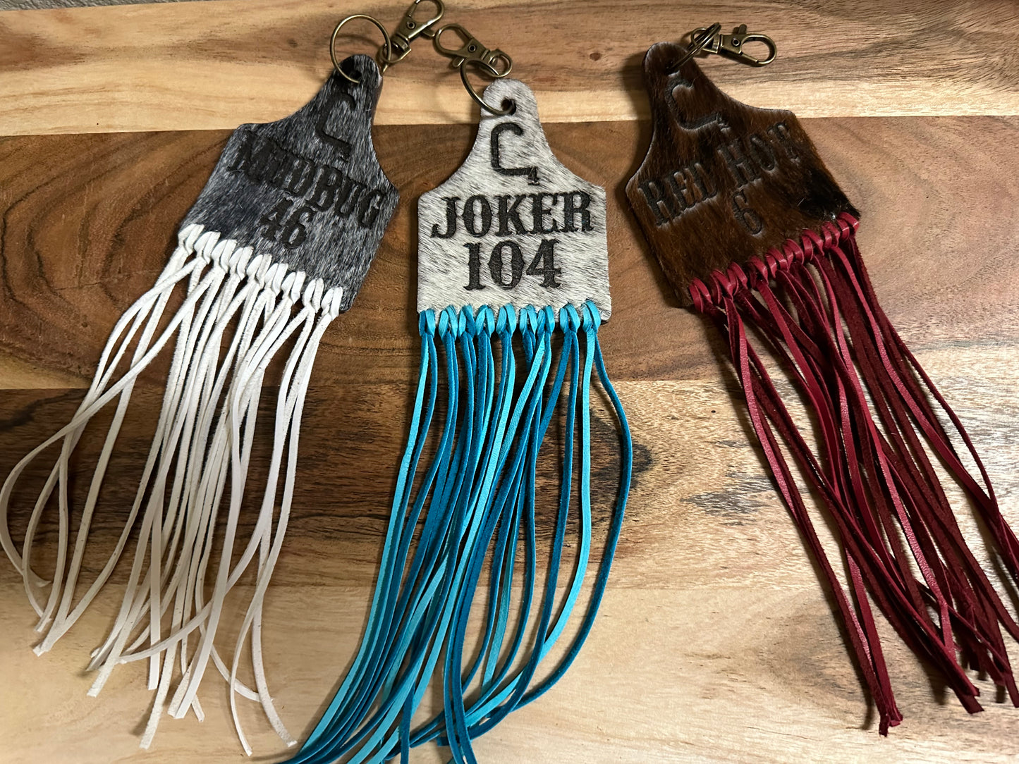 Custom cow tags keychains white/black hair on hide with turquoise fringe