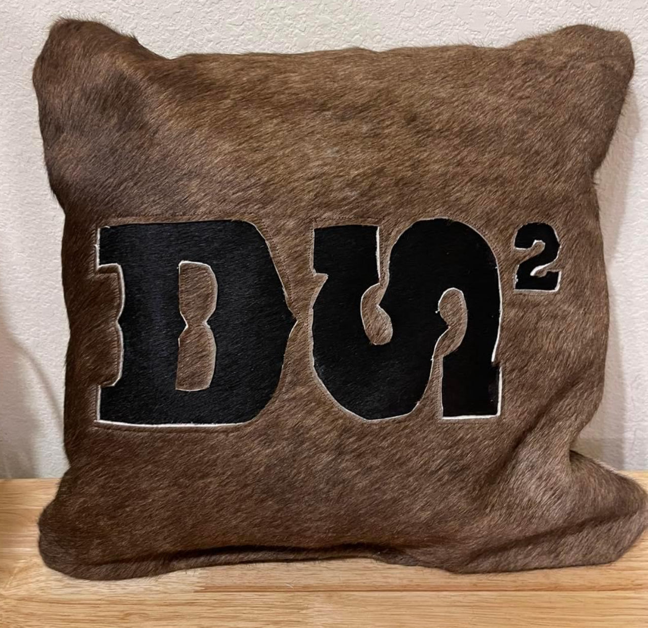 Cowhide pillow with brand cutout