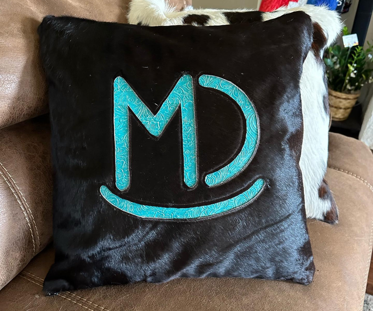 Cowhide pillow with brand cutout